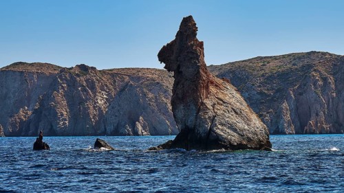 Bear rocks, distinctive rock formation on the coast overlooking the calm, blue sea, Koudes,