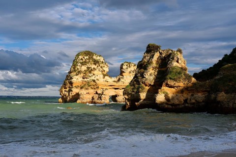 Rock formations on the coast in the evening light, Praia do Camilo, Lagos, Algarve, Portugal