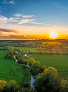 Sunset of Fields and Farms over Horsebridge nad Stockbridge from a drone, Hampshire, England,