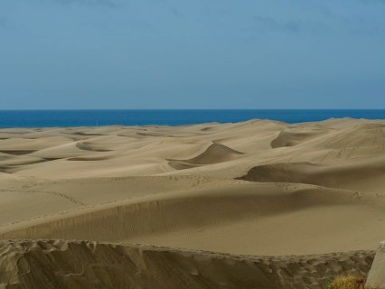 Extensive dune landscape down to the sea under slightly cloudy sky, dunes of Maspalomas, Gran