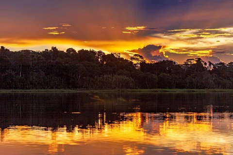 Dramatic sunset with clouds over a river in the Amazon, sunset on the Beni River near Rurrenabaque