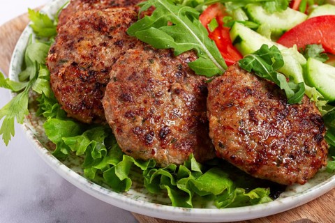 Fried cutlets, mixed minced meat, with vegetable salad, homemade, top view, no people
