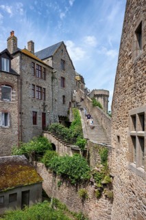 Historic stone steps and narrow streets between medieval buildings on the Mont-Saint-Michel