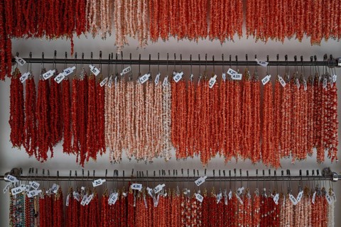 Sale of real corals, coral necklaces in pink, light red and red, Taormina, Sicily, Italy