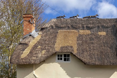 Animal wire figures on roof, thatched house, Bretforton, The Cotswolds, England, Great Britain