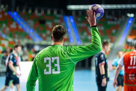 Handball goalkeeper throws ball during the match in Lubin, Poland