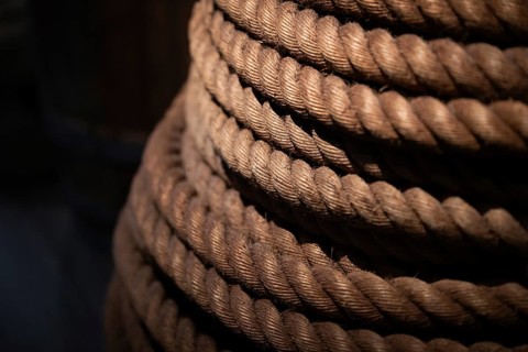 Close-up, thick rope layered on top of each other, illuminated in contrast between light and