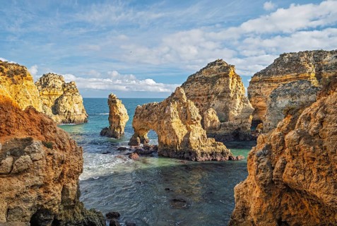 From inside the cove, Ponte da Piedade in Lagos, Algarve, Portugal, surrounds the ocean with cliffs
