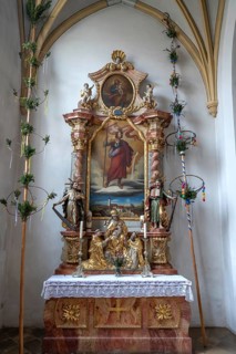 Palm bushes ready for the Palm Sunday procession at a side altar in the parish church of the Most