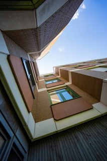 View from below of a modern building with an interesting architectural representation against the