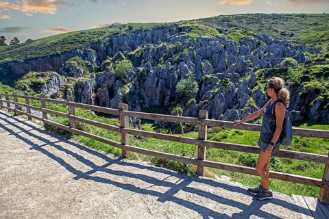 Middle aged woman contemplates the Buferrera mines at the Covadonga lakes ensemble, Picos de Europa