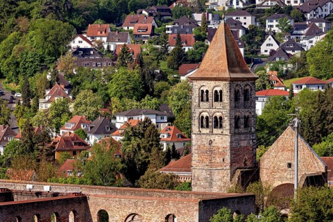 A picturesque village with an old church, surrounded by lush greenery and traditional houses, The