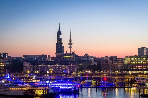 Aerial view of Landungsbrücken at sunrise on the Elbe with St Michael's Church (Michel) and