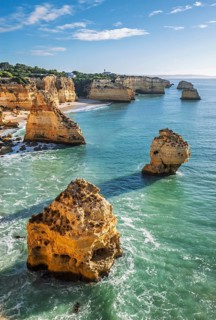 View of Praia da Marinha beach in Algarve, Portugal, with ocean cliffs, sea stacks and Atlantic