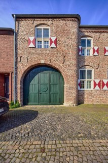 House Wachtendonk, old town center, historic brick building, façade with windows, shutters and wall