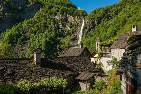 Picturesque mountain village with traditional old stone houses and waterfall, Foroglio, Bavona