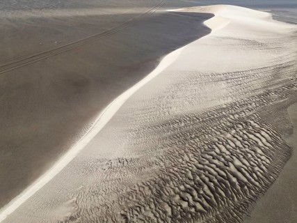 Barchan dune and sand patterns in the Namib Desert. Aerial view. Drone shot. Skeleton Coast,