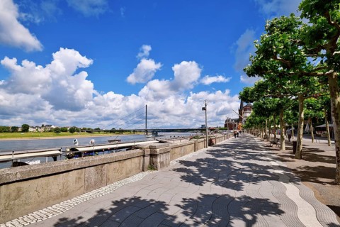 Düsseldorf, Germany - June 9th 2026: Riverside promenade 'Rheinuferpromenade' with Rhine River, and