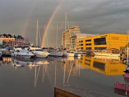 Rainbow and reflections in water in modern harbor with yachts, University, Kalmar, Kalmar Län,