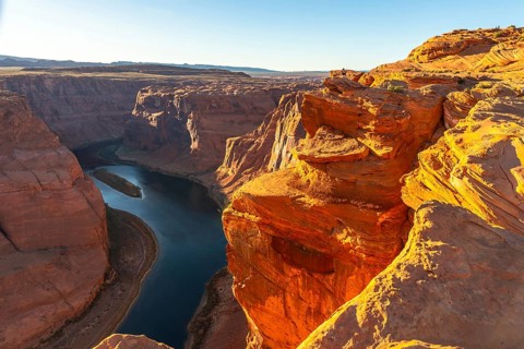 Horseshoe bend, a dramatic meander of the colorado river, winds through the deeply eroded sandstone