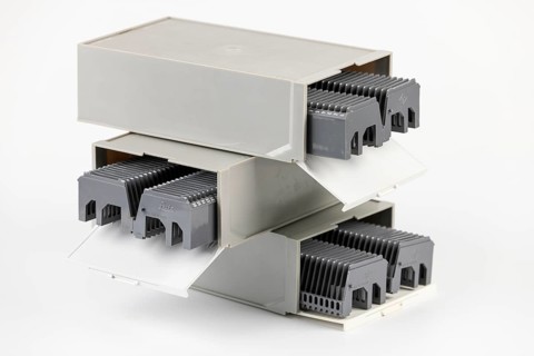 Three gray boxes stacked on top of each other for slides with magazines