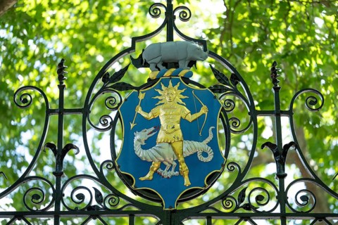 The Greek god Apollo (god of light, healing and medicine) with an arrow, bow and a halo, the coat