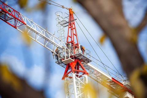Crane operators work at a frenzy rithm to get everything ready for the next formula one grand prix