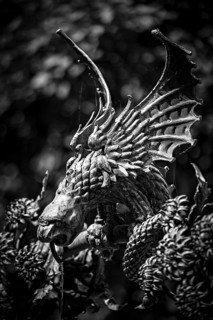 A detailed black and white dragon sculpture with distinctive wings and artistic details,