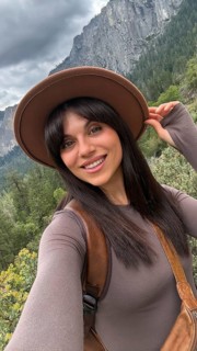 Smiling woman taking a selfie while enjoying the natural beauty of yosemite national park,