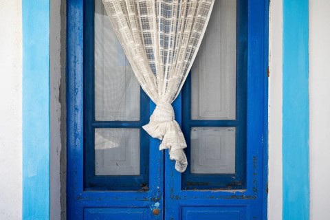 Blue and white front door, white curtain, Malfa, Salina, Aeolian or Lipari Islands, Southern Italy,