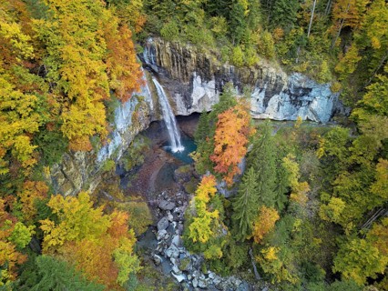 Aerial view of Berglistüber waterfall in autumn-colored surroundings, Linthal, Klausenpass, Canton