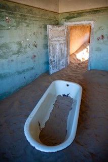 Interior view, bathtub and house full of sand, former diamond mining town, Namib Desert,