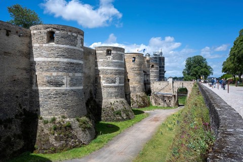 Side view of the monumental medieval fortification with its characteristic striped round towers and