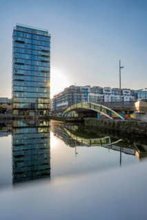 Skyscraper with water reflection and bridge, during sunset, Dublin, Ireland