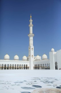White minaret and mosque domes against blue sky with floor pattern, Sheik Zayed Mosque, Sheikh