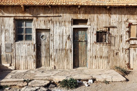 Rustic cabin with weathered wooden façade, traditional wooden coastal architecture, detail, doors