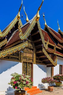 Artfully decorated gable roof with gilded ornaments, Buddhist temple complex Wat Phra That Si Chom