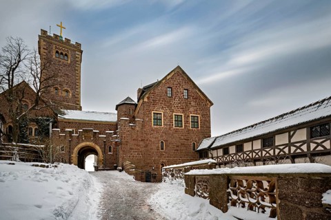 Historic castle with tower and archway in the snow, The Wartburg near Eisenach in Thuringia