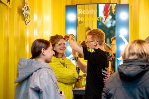A woman has her makeup done at the stand of discounter Lidl at Rock im Park Festival on Zeppelin