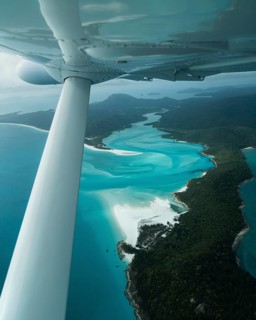 Aerial view of Whitsunday Island beach with airplane propeller and aircraft wing, Airlie Beach,
