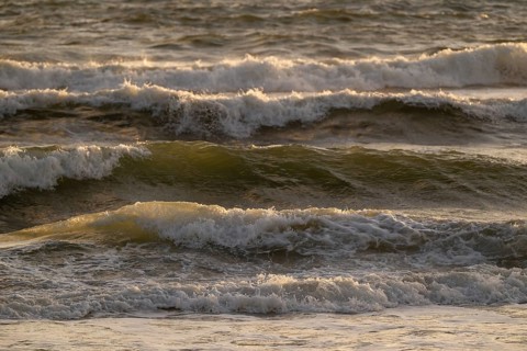 Surf, breaking waves with spray against light, Sortebærdalen Strand, Houvig, North Sea, Denmark