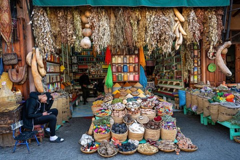 Various dried herbs, spices, soap and fragrances are on display for sale at a sales stand, spice