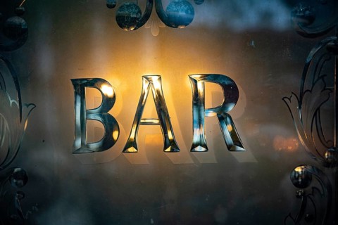 A British pub window design with the word Bar displayed, outside a traditional London Pub, UK