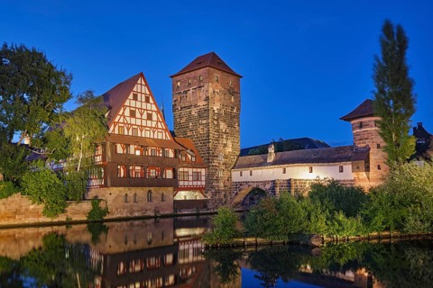 Night view of the picturesque Henkersteg bridge and traditional houses in the old town of