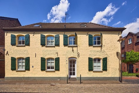Historic city center, historic brick building, façade with windows and shutters, wall anchor,
