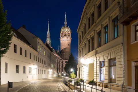 Schlossstraße in the evening with castle church tower and Röhrwasser, Luther city Wittenberg,
