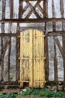 Old, dilapidated wooden door on a half-timbered house in the old town of Troyes, Aube department,