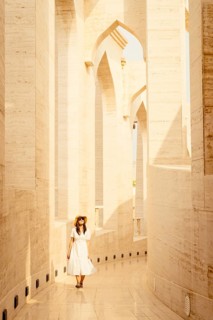 Doha Qatar Katara Cultural Village woman in white dress walking amphitheater traditional