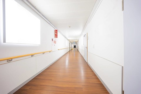 Long corridor with wooden floor in a modern and bright interior, old disused hospital, Calw,