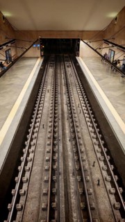 Symmetrical view of subway tracks in an underground station, Lisbon, Portugal